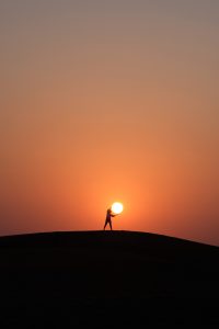 Image of person and setting sun